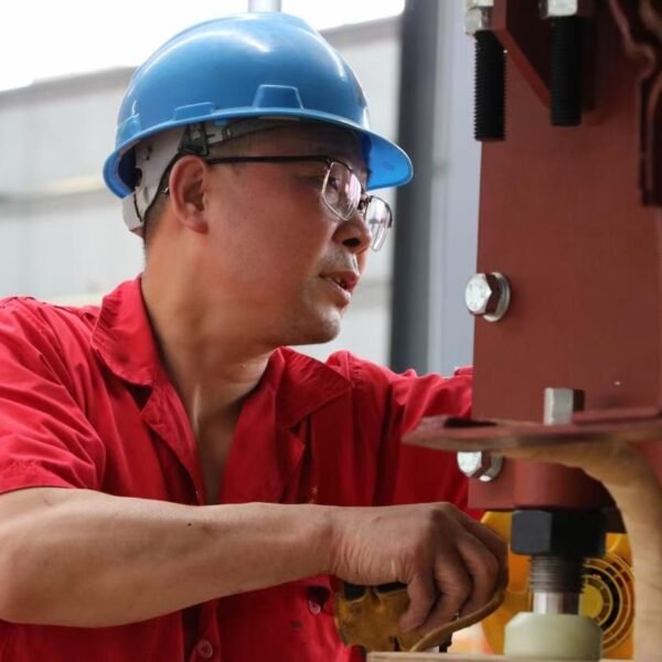 Technician inspecting a transformer during assembly