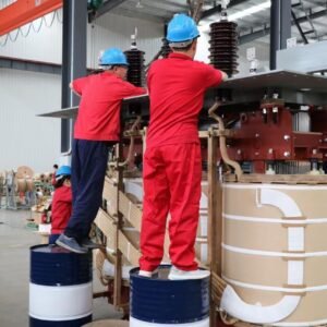 Workers assembling the active part of a transformer
