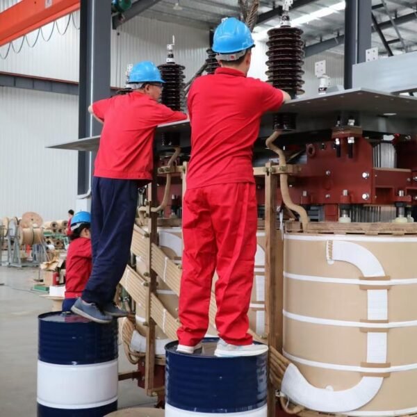Workers assembling the active part of a transformer