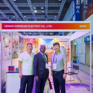 International visitor with the XNET team at a transformer exhibition booth