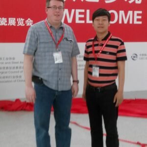 XNET representative welcoming an international visitor at a power industry exhibition