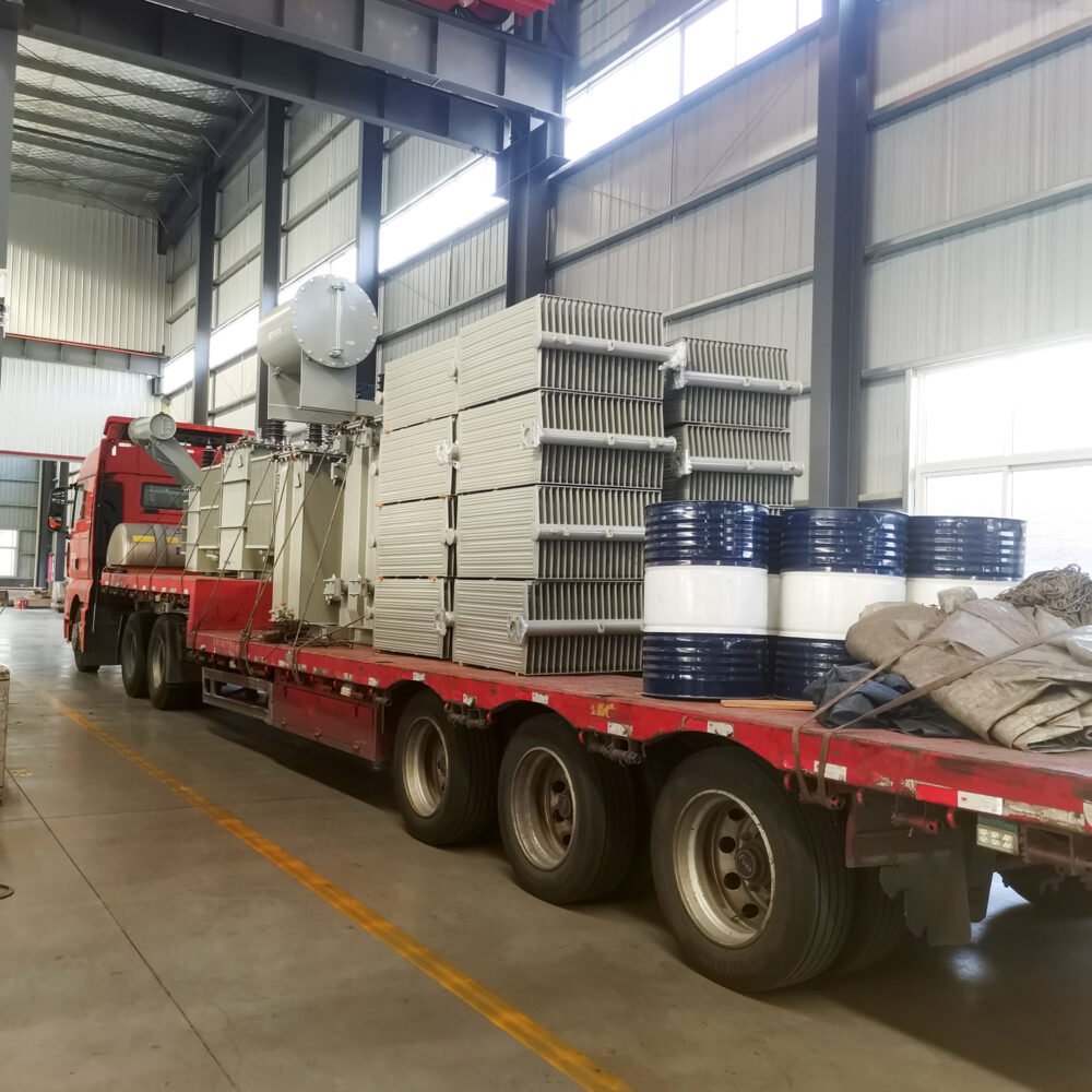 Power transformer loaded onto a flatbed truck inside the factory