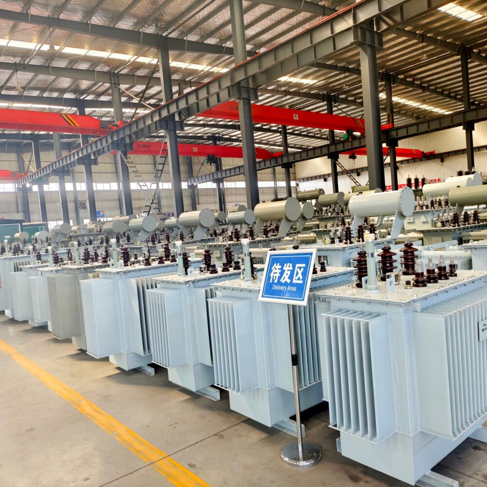Finished distribution transformers arranged on the factory floor