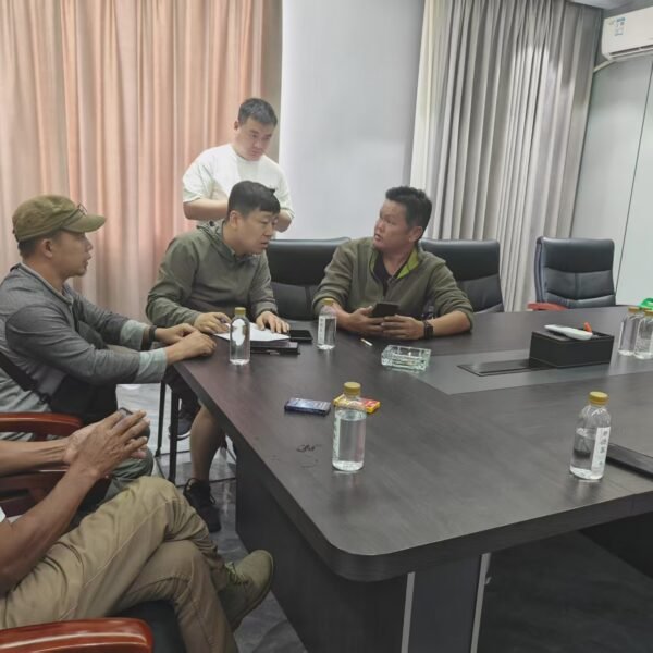 Customer delegation discussing transformer requirements in the XNET factory meeting room
